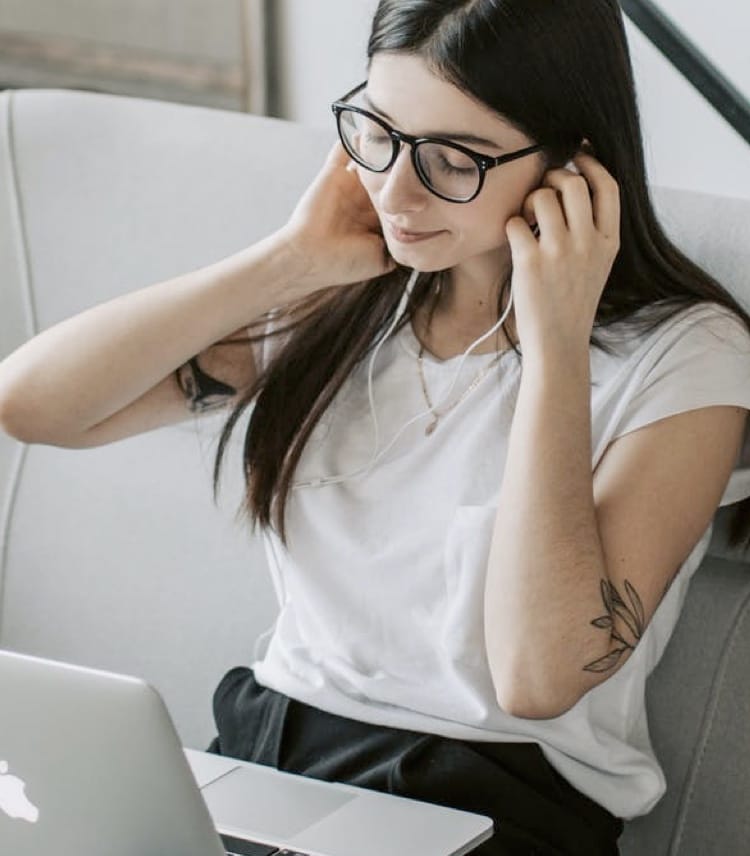 A woman on a call through headphones